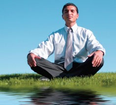photo of a young businessman meditating in the grass - hired power - recovery care management
